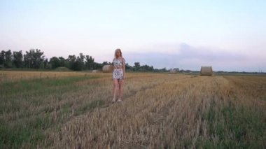 Slow Motion Photo of glad girl enjoying life in wheat meadow