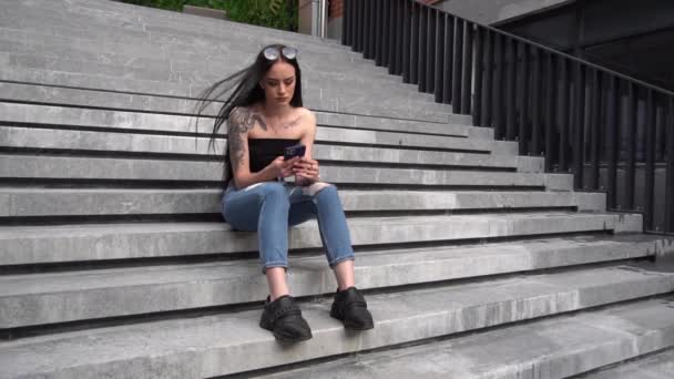 Slow Motion Young Woman Using Mobile Phone While Sitting Stairs — Stockvideo