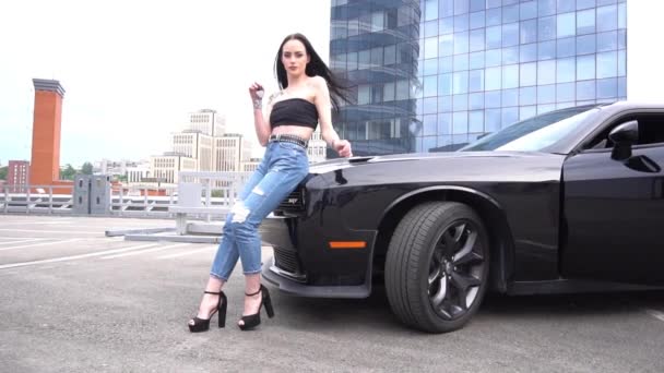 Slow Motion Female Blue Jeans Black Top Posing Black Car — Vídeos de Stock