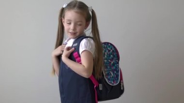 Slow Motion Portrait of schoolgirl keeping backpack isolated on white background