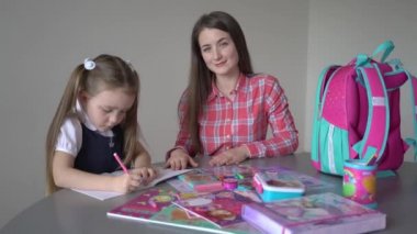 4k Mother helping adopted child with art homework