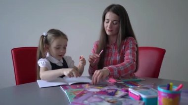 4k Happy family preparing for school. Little girl with mother.