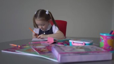 Little cute girl doing her homework.