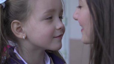 Slow Motion little girl embracing her mom before the preschool day