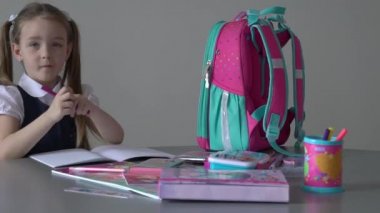 Cute smart little 7s girl child sit at table at home prepare homework alone. 