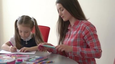 Slow Motion Girl doing homework with mother