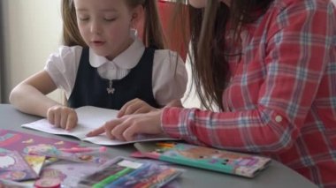 Slow Motion mom helping her little daughter do her homework
