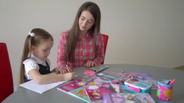 Little Girl Doing Homework Her Mother — стоковое видео