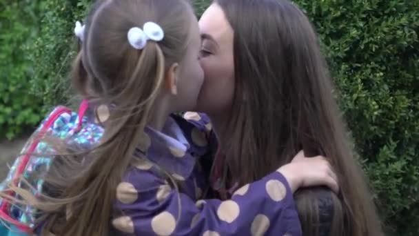 Young Beautiful Mother Hugging Her Daughter School Bag Front School — Stockvideo