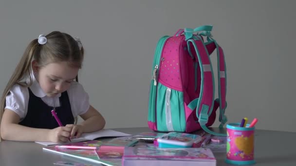 Slow Motion Little Girl Writing Something Copybook Sitting Table — стоковое видео