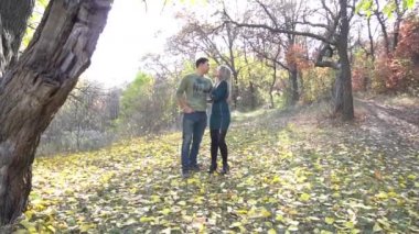 Slow Motion Loving Mature Couple Walking Along Track In Autumn Countryside