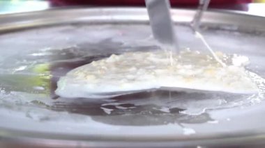 Slow Motion Thailand stir-fried ice cream rolls at freeze pan. 