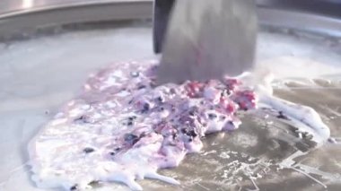 Slow Motion art of making Thai ice-cream in the street, strawberry rolls.