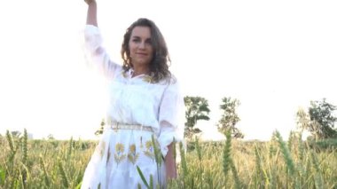 Slow Motion Woman with arms outstretched in a wheat field