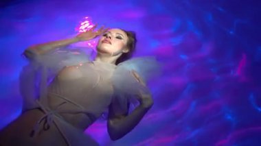 Diving under the water with a shiny cloth