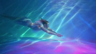 Slow Motion Beauty young bride in wedding dress falling underwater