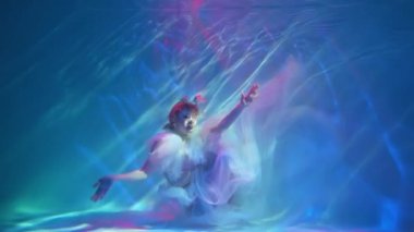 Slow Motion Diving under the water with a shiny cloth