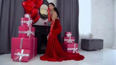 Slow Motion sensual elegant young woman in red dress indoor with balloons 