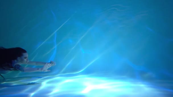 Slow Motion Girl Long Dark Hair Swims Underwater — Stock video