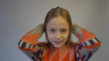 4k The child is offended and angry. Girl on a gray background