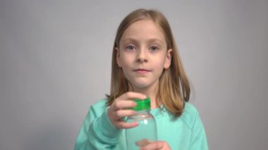 4k girl drinking from a plastic bottle of mineral water.