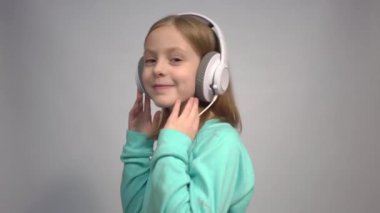 4k Happy smiling girl enjoys listens to music in headphones 