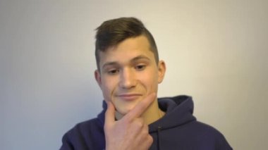 4k Teenager boy with hand on chin thinking about question, pensive expression