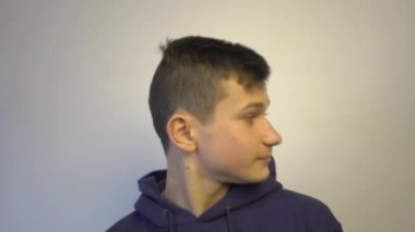 4k Surprised young caucasian man makes silence gesture, keeps finger over lips