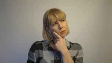 4k Close up of serious thoughtful woman, thinking, looking perplexed 