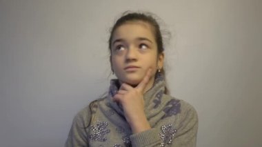 4k young school girl happy positive smile dream think and don't have an answer 