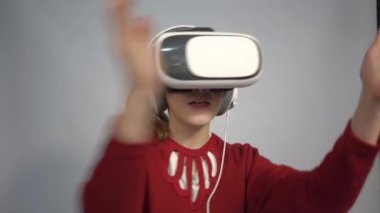 4k girl at home in virtual reality VR glasses watching video, playing games