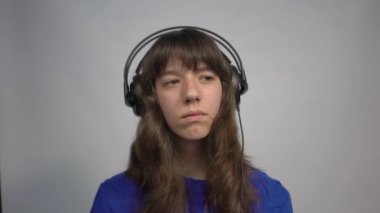 4k adorable girl listen sad music headphones. Play any song.