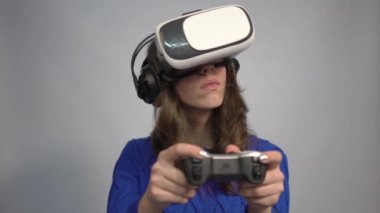 4k Child with virtual reality headset and joystick playing video games