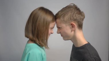 4k Two children with opposite emotions, sister watching at her brother 