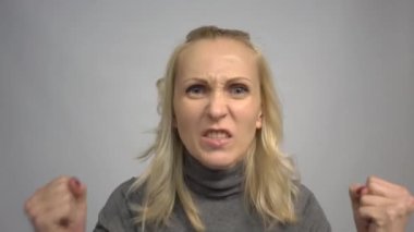 4k Angry woman screaming on gray background