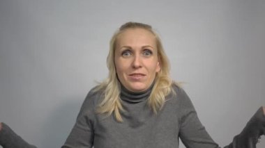 4k portrait of shy awkward young woman feeling embarrassed, confused and puzzled