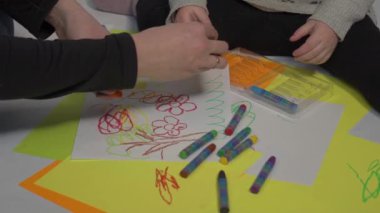 Little caucasian siblings drawing together on floor in living room at home. 