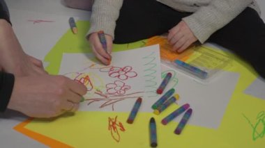 Slow Motion Little girl painting while sitting on floor at home