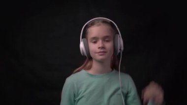 4k Child listening music with headphones. Headset device accessory. 