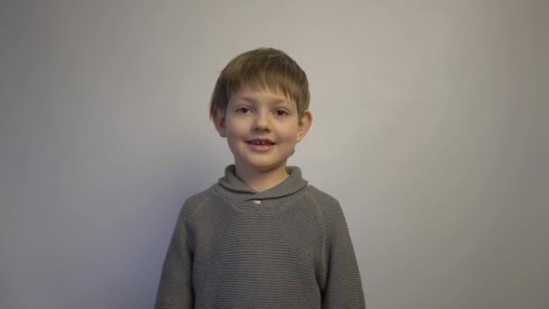 Happy Young Caucasian Boy Isolated Gray Background — Video