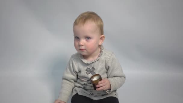 Adorable Blonde Caucasian Toddler Girl Applying Cream Her Face — Vídeo de Stock