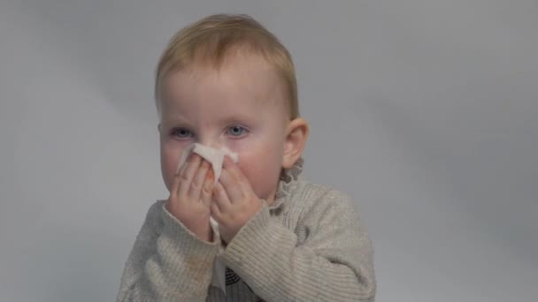 Медленное Движение Ребенок Очищает Нос Тканями Изолированы Сером — стоковое видео