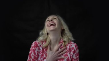4k Middle age caucasian woman isolated on black background laughing