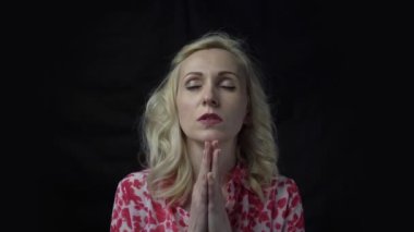 4k Calm middle age woman hold hands in pray