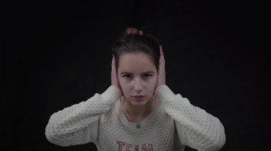 4k Frustrated Young Caucasian girl plugging ears with hands and screaming 