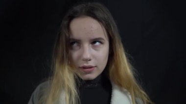 4k young woman makes face palm over black background