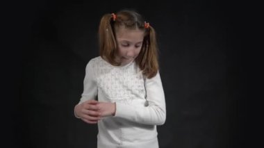 4k Positive young Caucasian woman has shy expression, blinks eyes