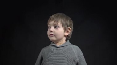 4k Boy thinking over black background