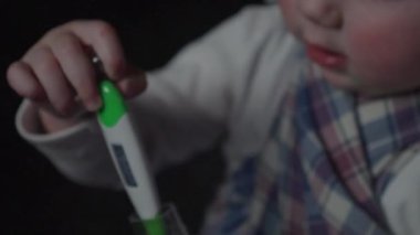 The child has a high fever or fever shows a digital thermometer.