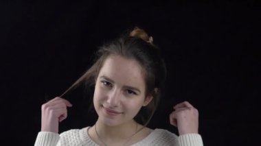 Slow Motion young woman smiling on black background 
